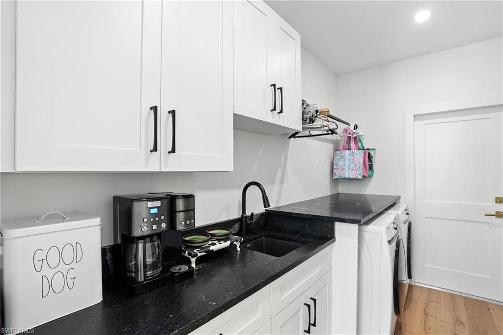 581 Wedgewood Way Naples, FL 34119 - Photo 22 of 33 a kitchen with granite countertop a sink a stove and cabinets
