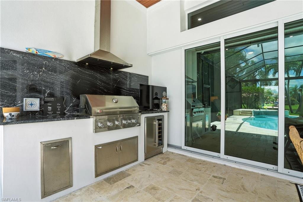 581 Wedgewood Way Naples, FL 34119 - Photo 23 of 33 a kitchen with a stove and a refrigerator