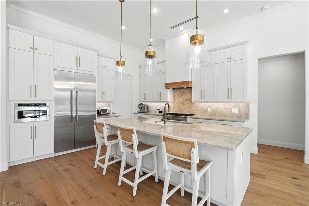 581 Wedgewood Way Naples, FL 34119 - Photo 4 of 33 a kitchen with stainless steel appliances granite countertop a sink a stove and a refrigerator
