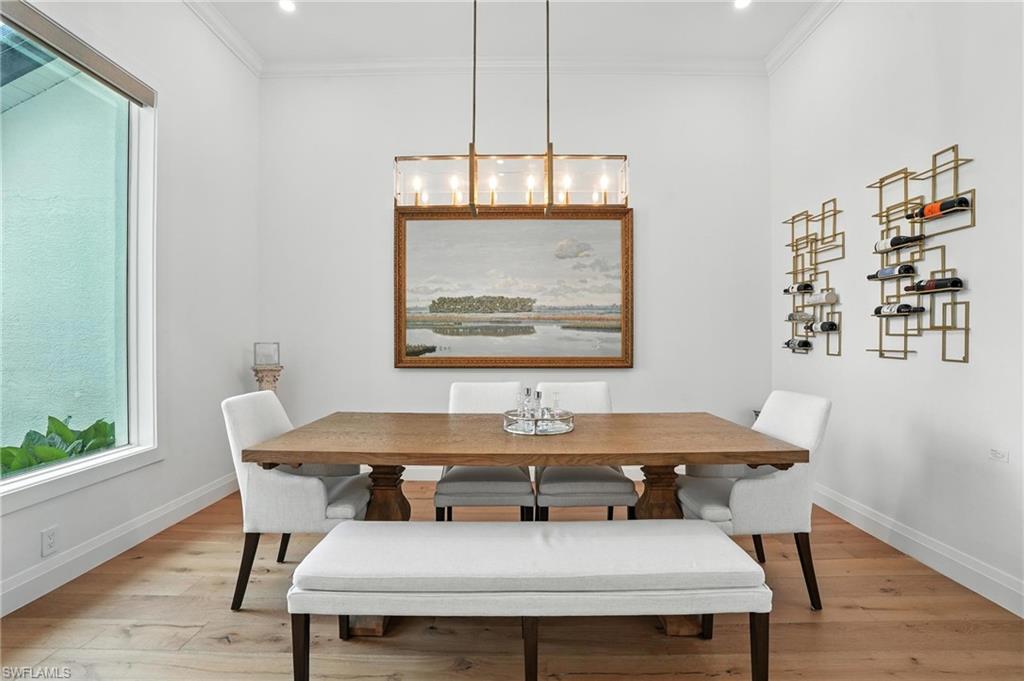 581 Wedgewood Way Naples, FL 34119 - Photo 8 of 33 a view of a dining room with furniture window and wooden floor