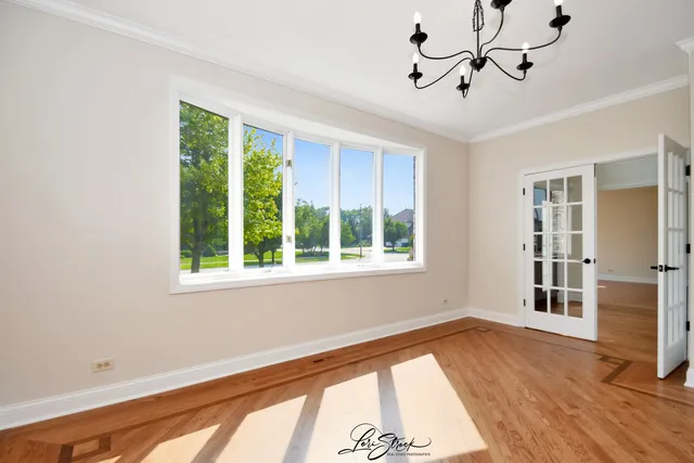 an empty room with windows and a fireplace