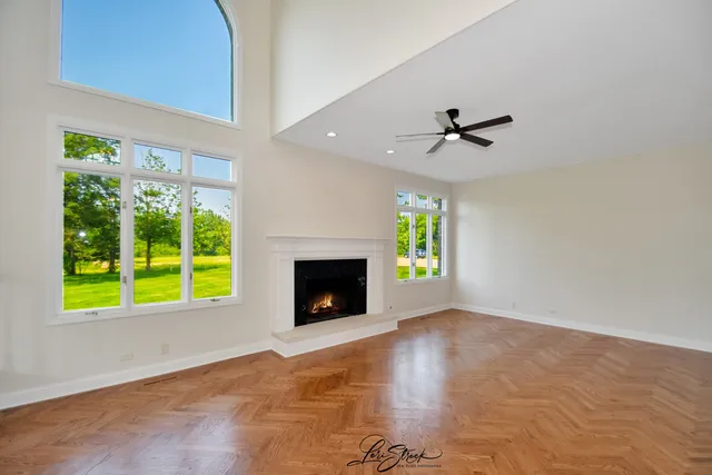 a view of an empty room with a fireplace and a window