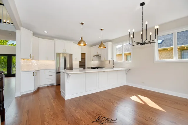 a kitchen with stainless steel appliances a refrigerator sink and stove