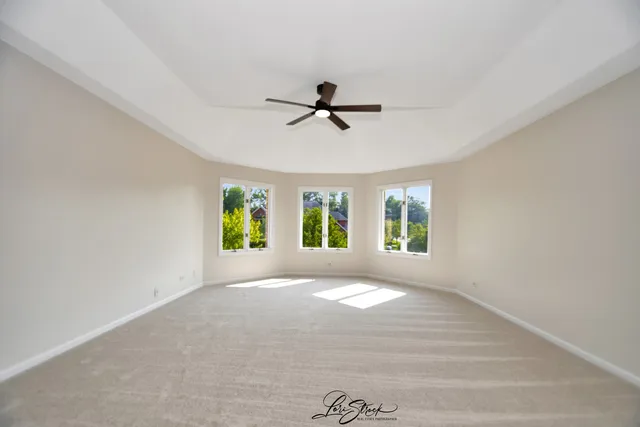 a view of a livingroom with a ceiling fan and window