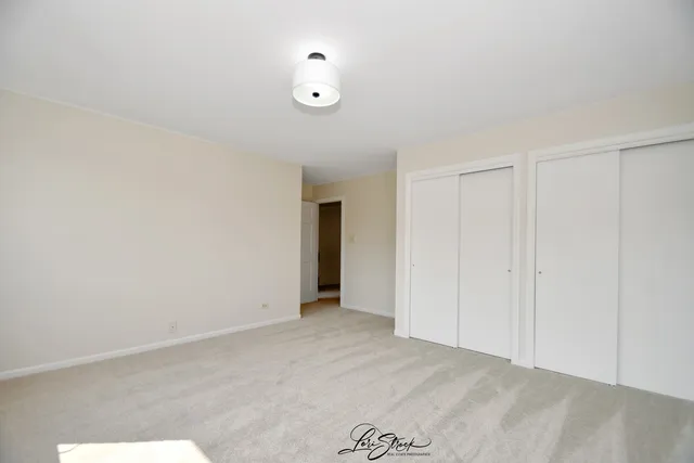 an empty room with windows and entrance