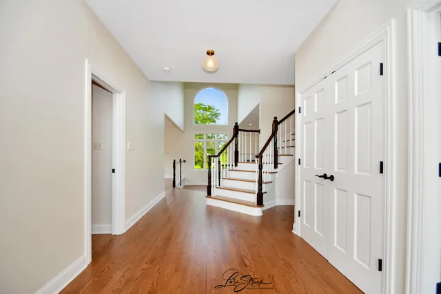 a view of entryway with wooden floor and stairs