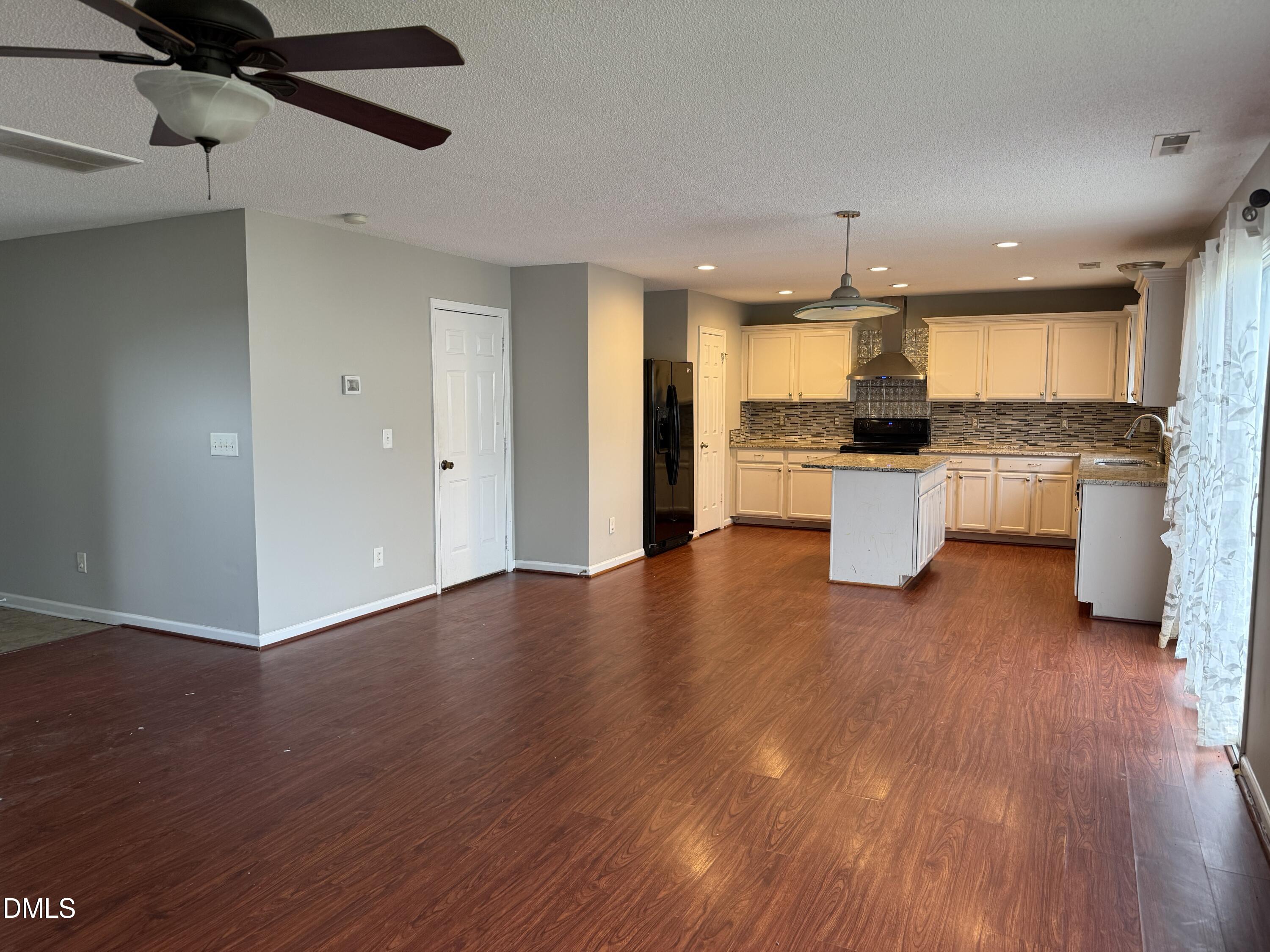 3133 Mackinac Island Lane Raleigh, NC 27610 - Photo 3 of 19 a view of a kitchen and dining room
