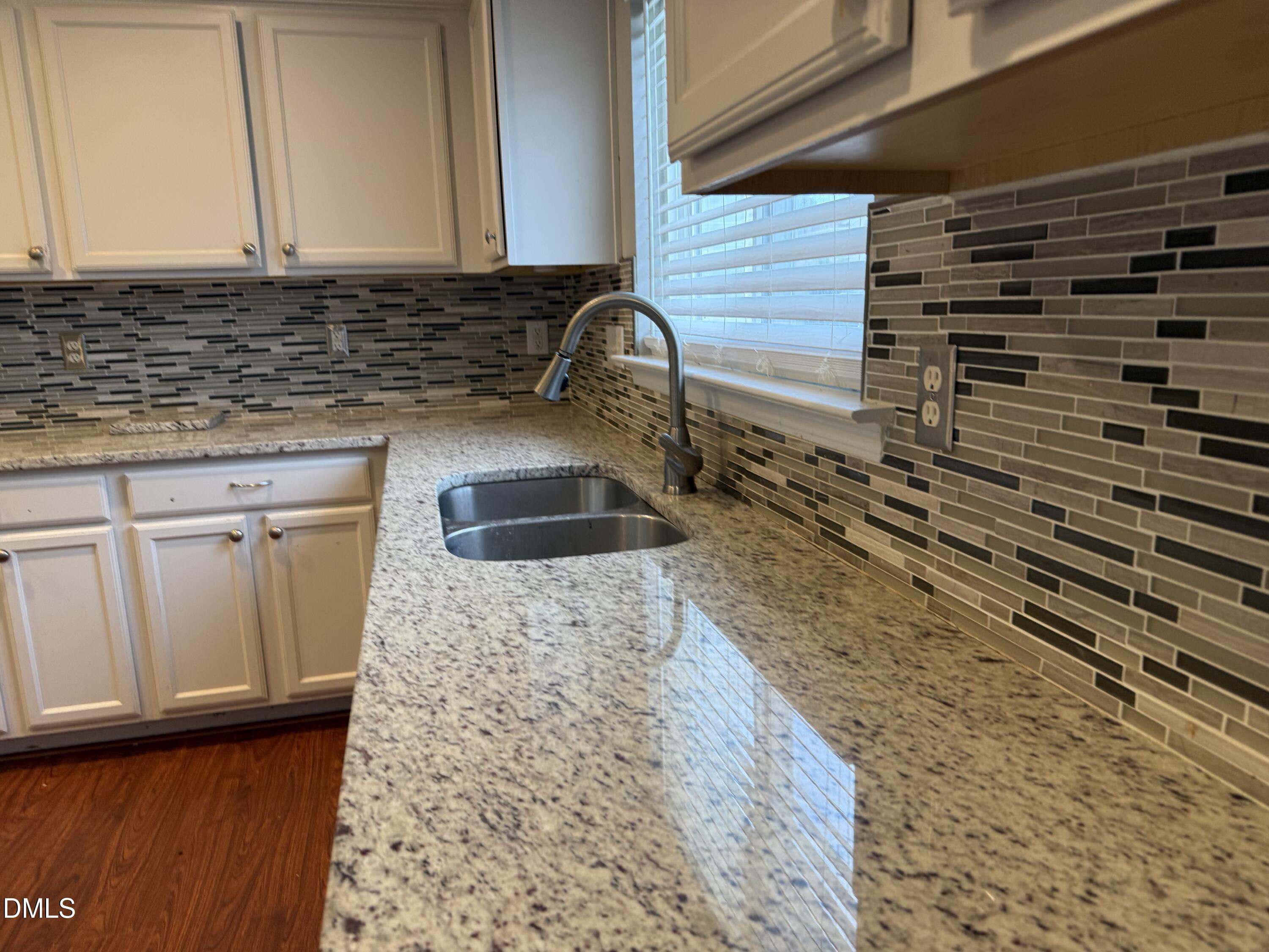 3133 Mackinac Island Lane Raleigh, NC 27610 - Photo 4 of 19 a bathroom with a granite countertop sink and a mirror