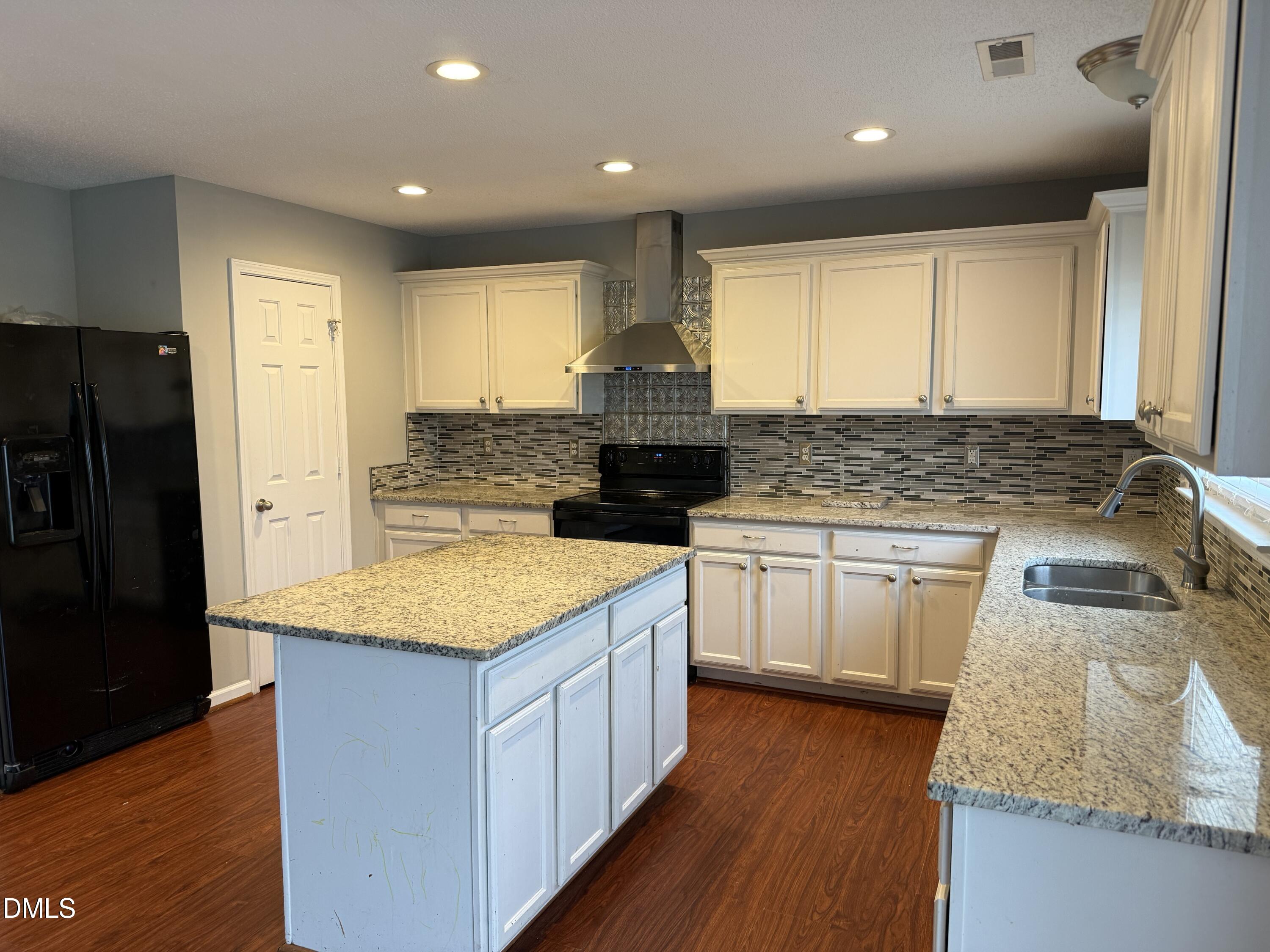 3133 Mackinac Island Lane Raleigh, NC 27610 - Photo 5 of 19 a kitchen with stainless steel appliances granite countertop a sink stove and refrigerator