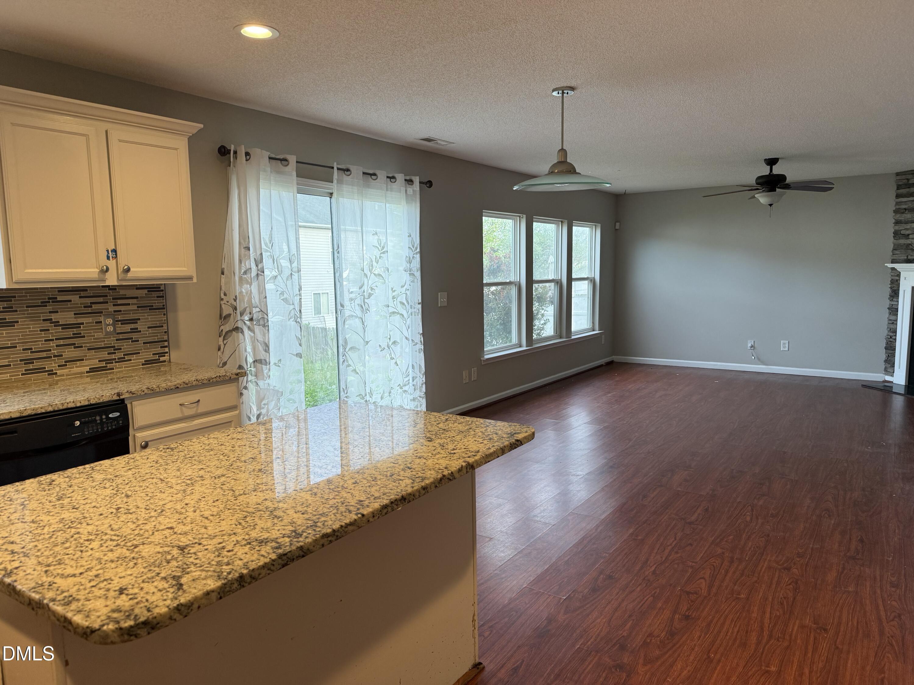 3133 Mackinac Island Lane Raleigh, NC 27610 - Photo 7 of 19 wooden floor in an empty room with a window