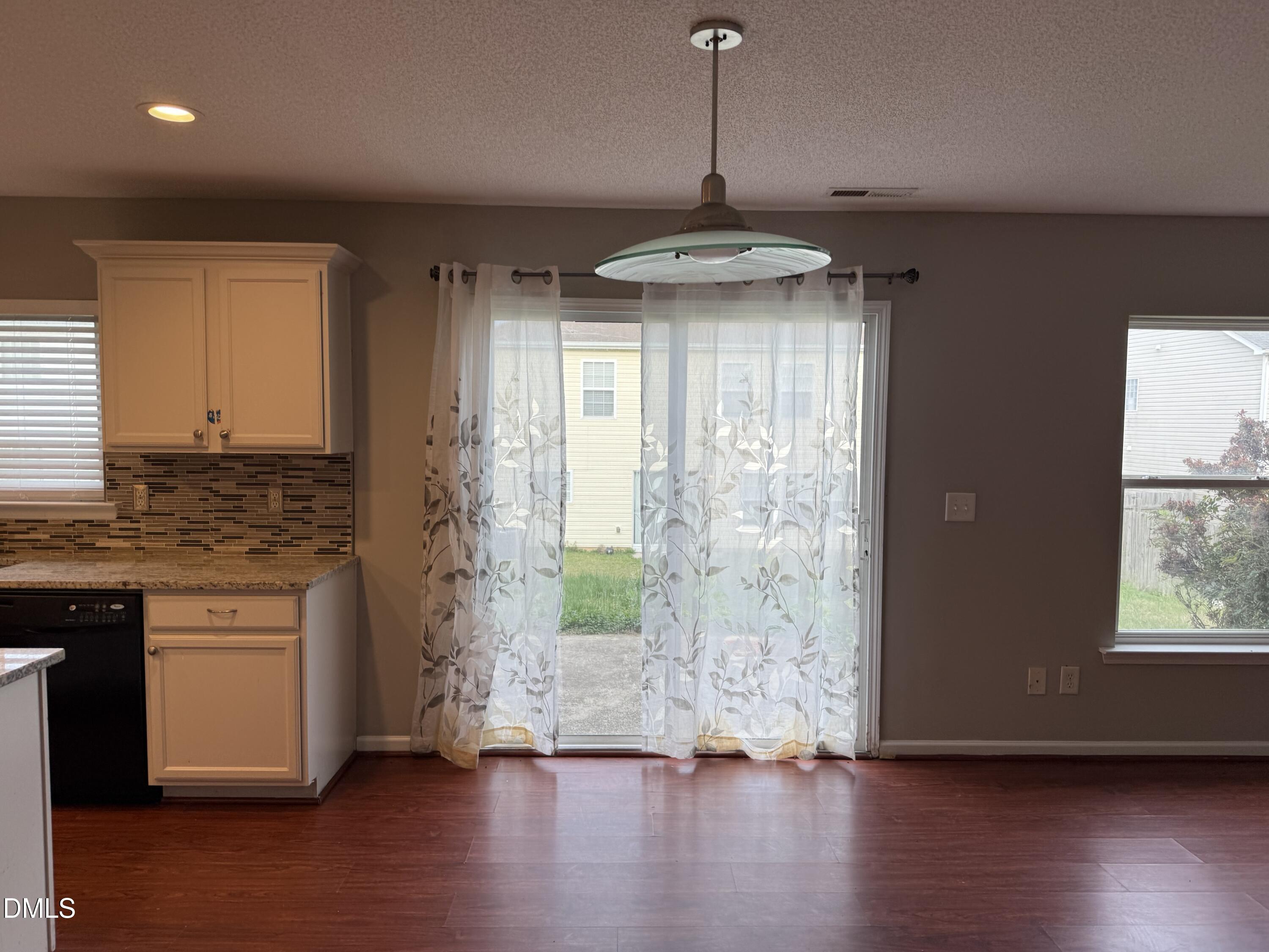 3133 Mackinac Island Lane Raleigh, NC 27610 - Photo 8 of 19 a view of an empty room with wooden floor and a window