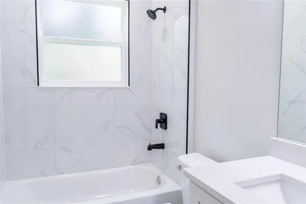 a bathroom with a bathtub and window
