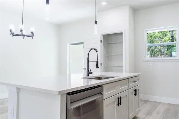 a kitchen with a sink and a window