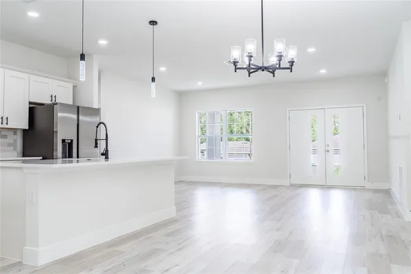a view of a room with chandelier and wooden floor