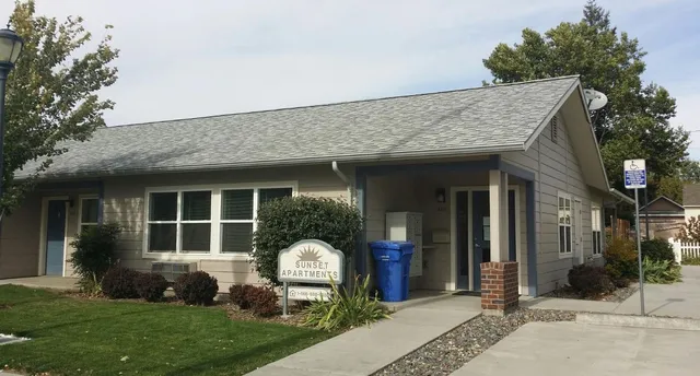 a view of a house with a garden and plants