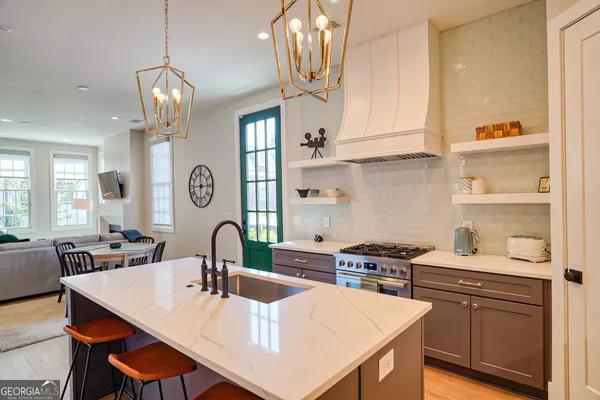 a kitchen with a table chairs stove and cabinets