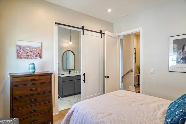 a bedroom with a bed and a lamp