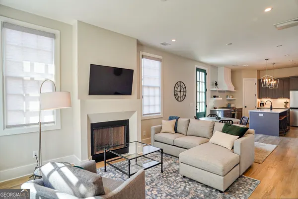 a living room with fireplace furniture and a flat screen tv