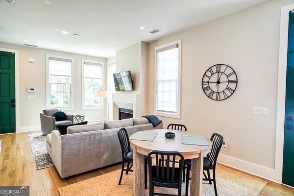 a living room with furniture a table and a large window