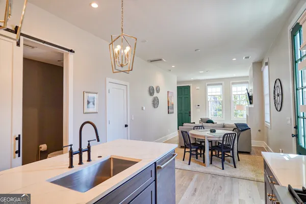 a kitchen with stainless steel appliances granite countertop sink table and chairs