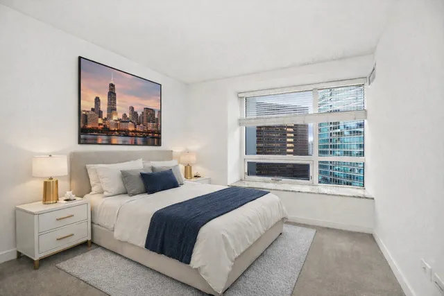 a spacious bedroom with a large bed and a window