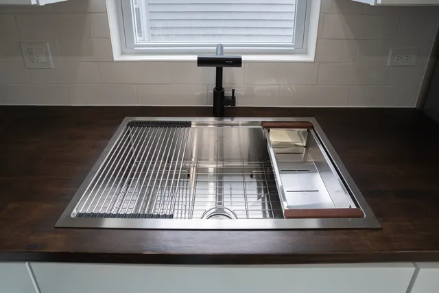 a kitchen with stainless steel appliances a refrigerator sink and microwave