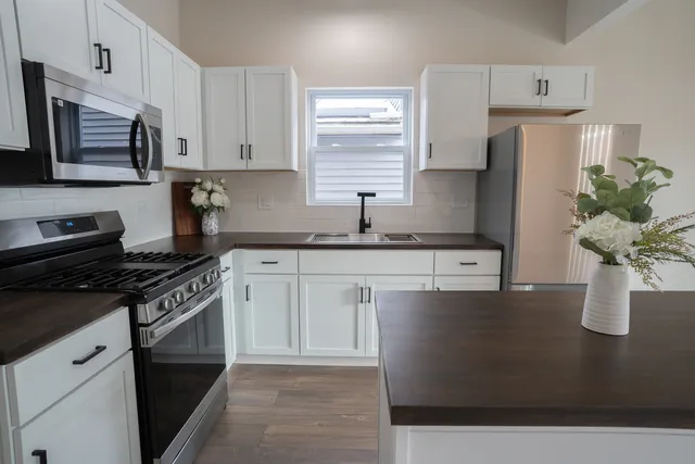 a view of a hallway with wooden floor and windows