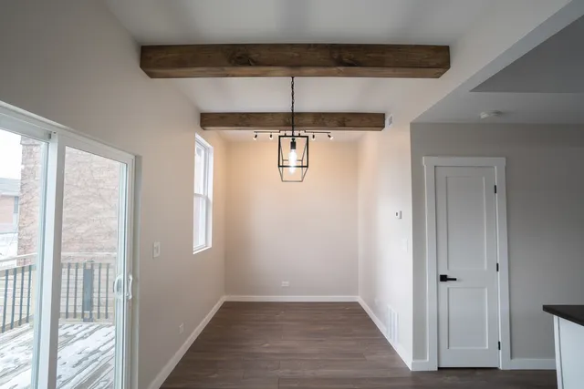 a view of a kitchen and a refrigerator
