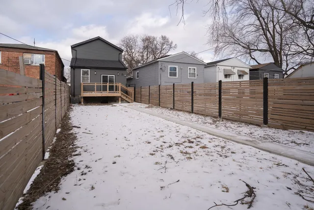 a view of a house with a yard covered in snow