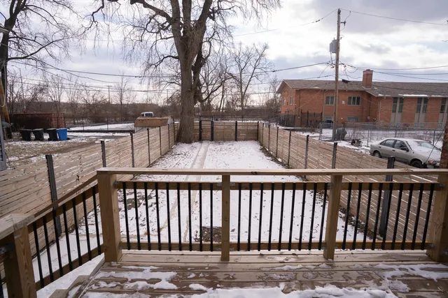 a view of a balcony with wooden fence