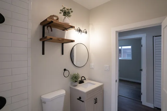 a bathroom with a sink toilet and mirror