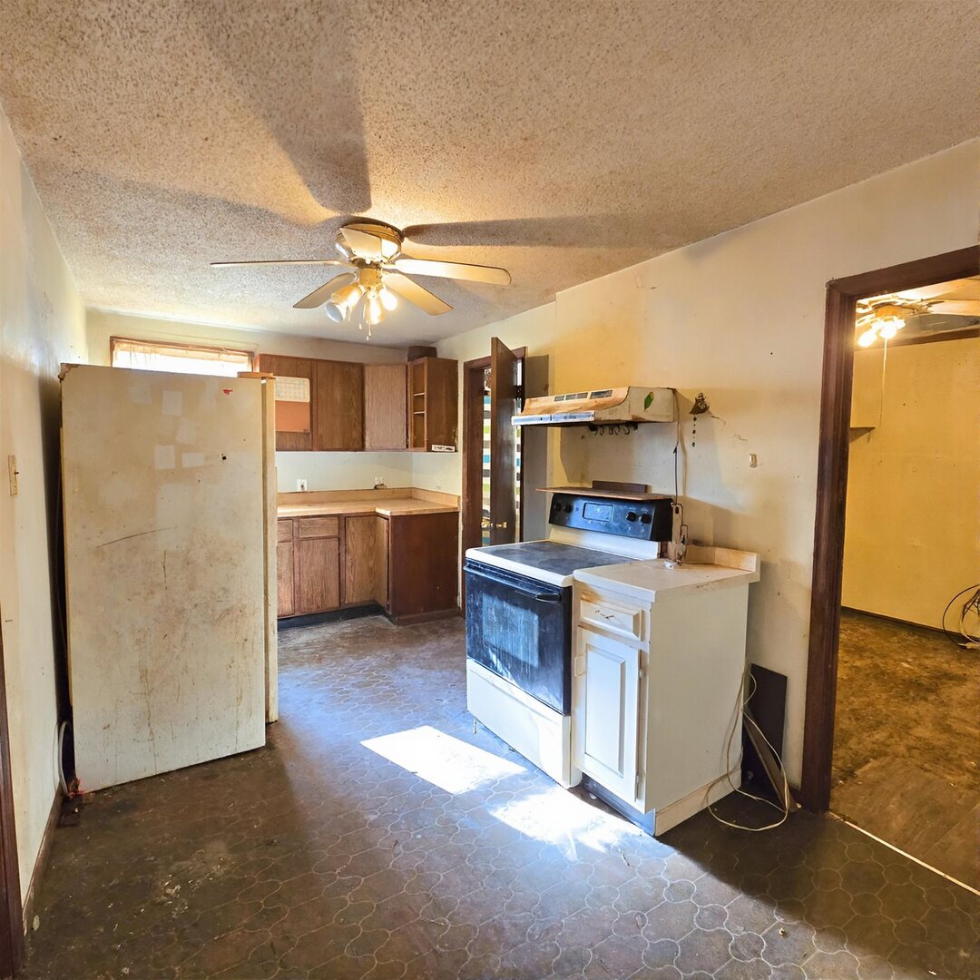 235 4th Avenue North Clinton, IA 52732 - Photo 6 of 11 a kitchen with a refrigerator and a stove top oven