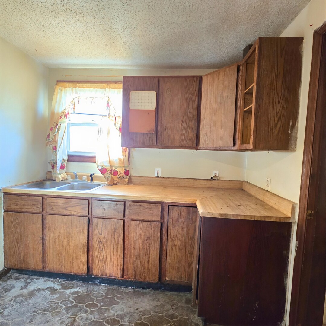 235 4th Avenue North Clinton, IA 52732 - Photo 8 of 11 a room with granite countertop cabinets sink and window