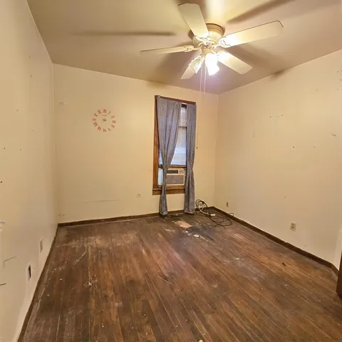 wooden floor in a hall with a window