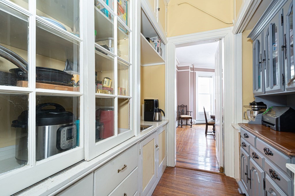 56 William Street Worcester, MA 01609 - Photo 12 of 37 a kitchen with stainless steel appliances granite countertop a lot of cabinets and wooden floor