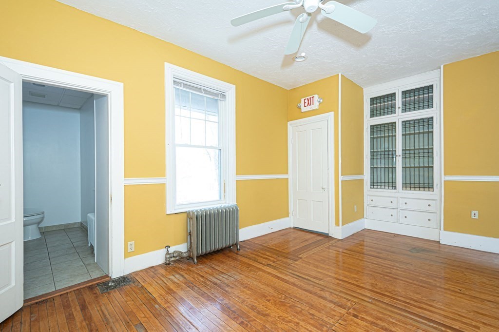 56 William Street Worcester, MA 01609 - Photo 17 of 37 a view of an empty room with wooden floor and a window