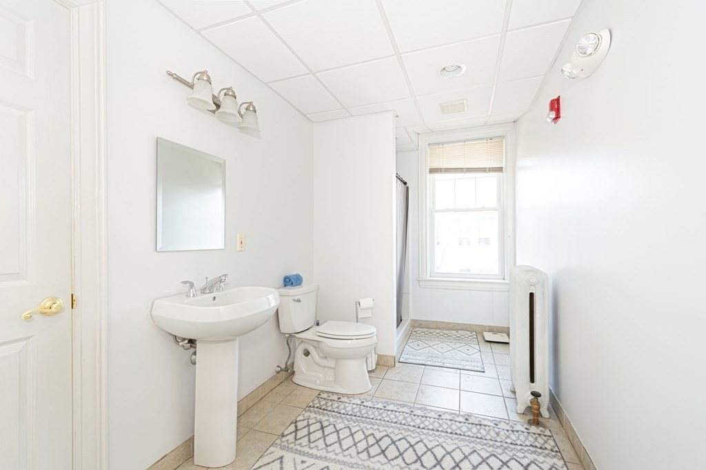 56 William Street Worcester, MA 01609 - Photo 22 of 37 a bathroom with a sink toilet and shower