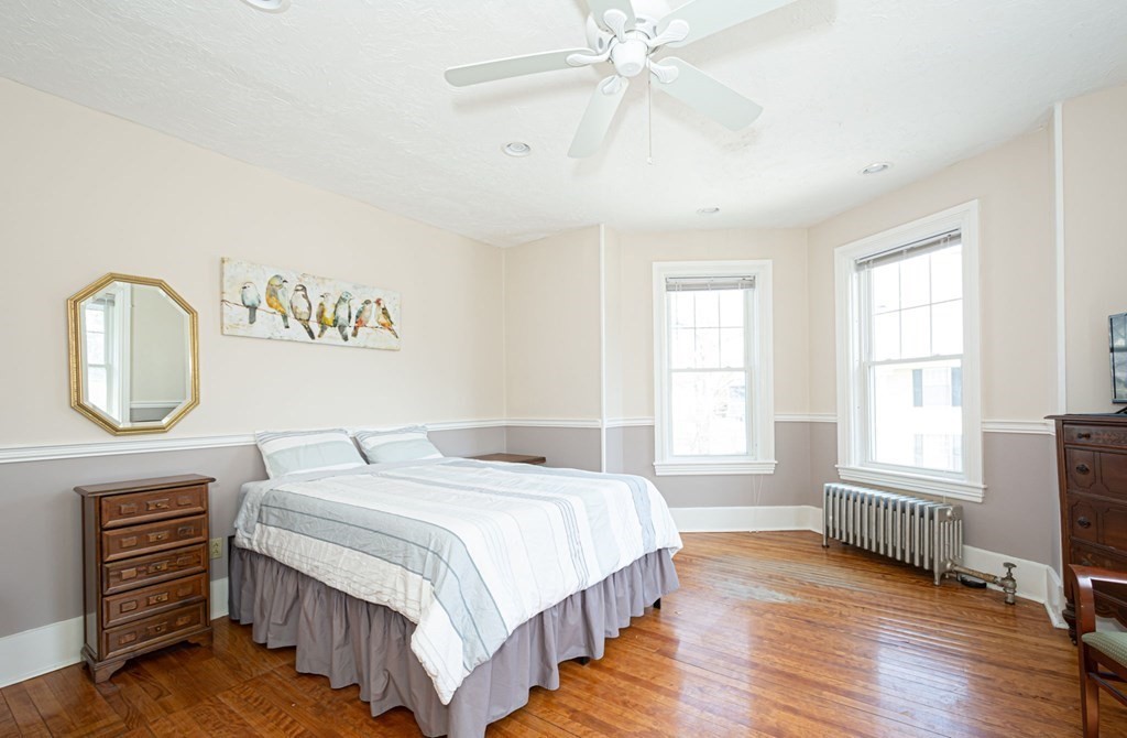 56 William Street Worcester, MA 01609 - Photo 23 of 37 a bedroom with a bed a dresser with wooden floor