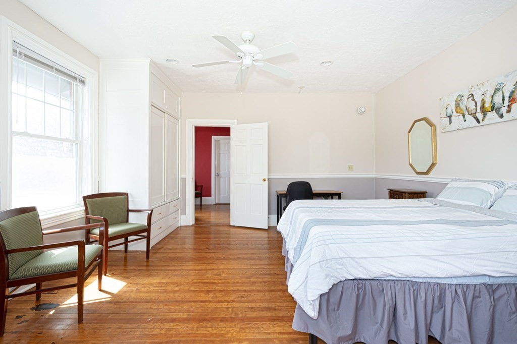 56 William Street Worcester, MA 01609 - Photo 24 of 37 a bedroom with a bed and wooden floor