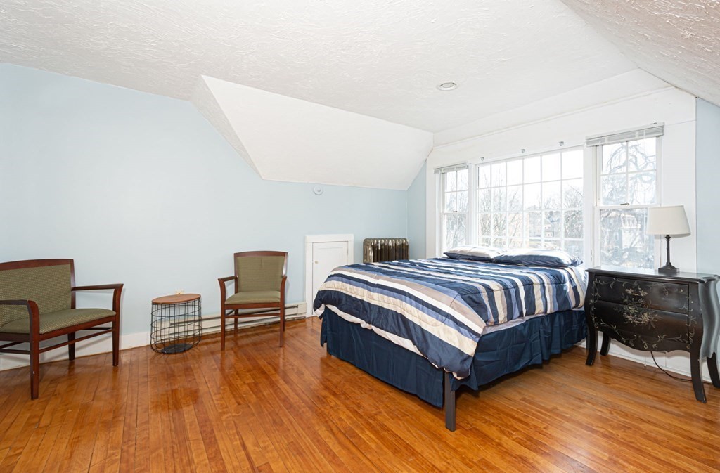 56 William Street Worcester, MA 01609 - Photo 27 of 37 a bedroom with a bed and wooden floor