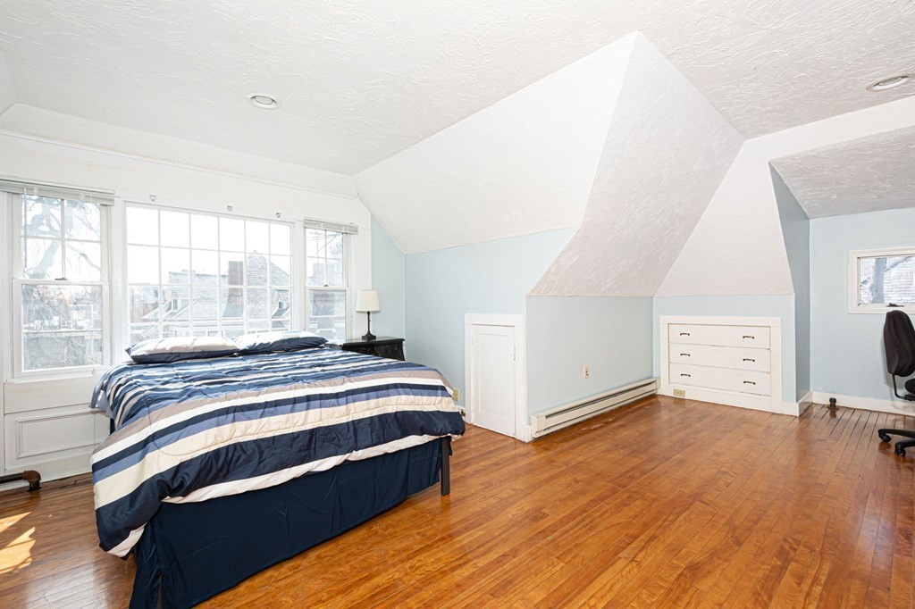 56 William Street Worcester, MA 01609 - Photo 28 of 37 a bedroom with a bed and wooden floor