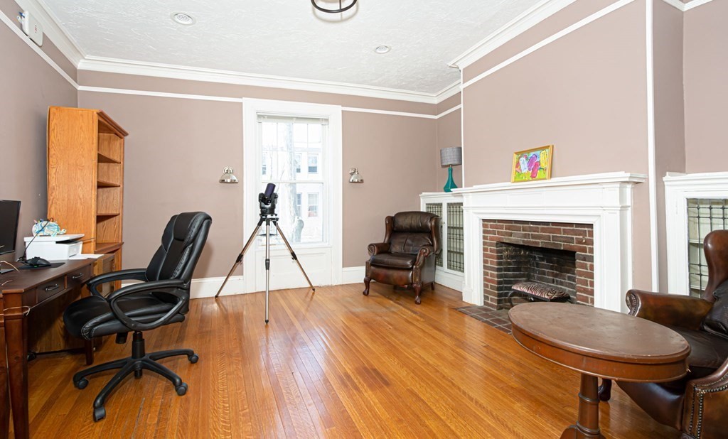 56 William Street Worcester, MA 01609 - Photo 7 of 37 a living room with furniture a fireplace and next to a window