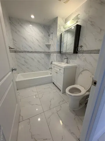 a bathroom with a toilet a sink and bathtub