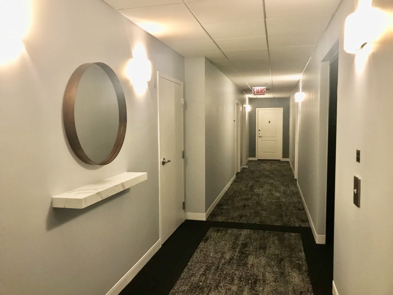 21 West Chestnut Street, Unit 1708 Chicago, IL 60610 - Photo 3 of 6 a view of a hallway with wooden floor and a bathroom