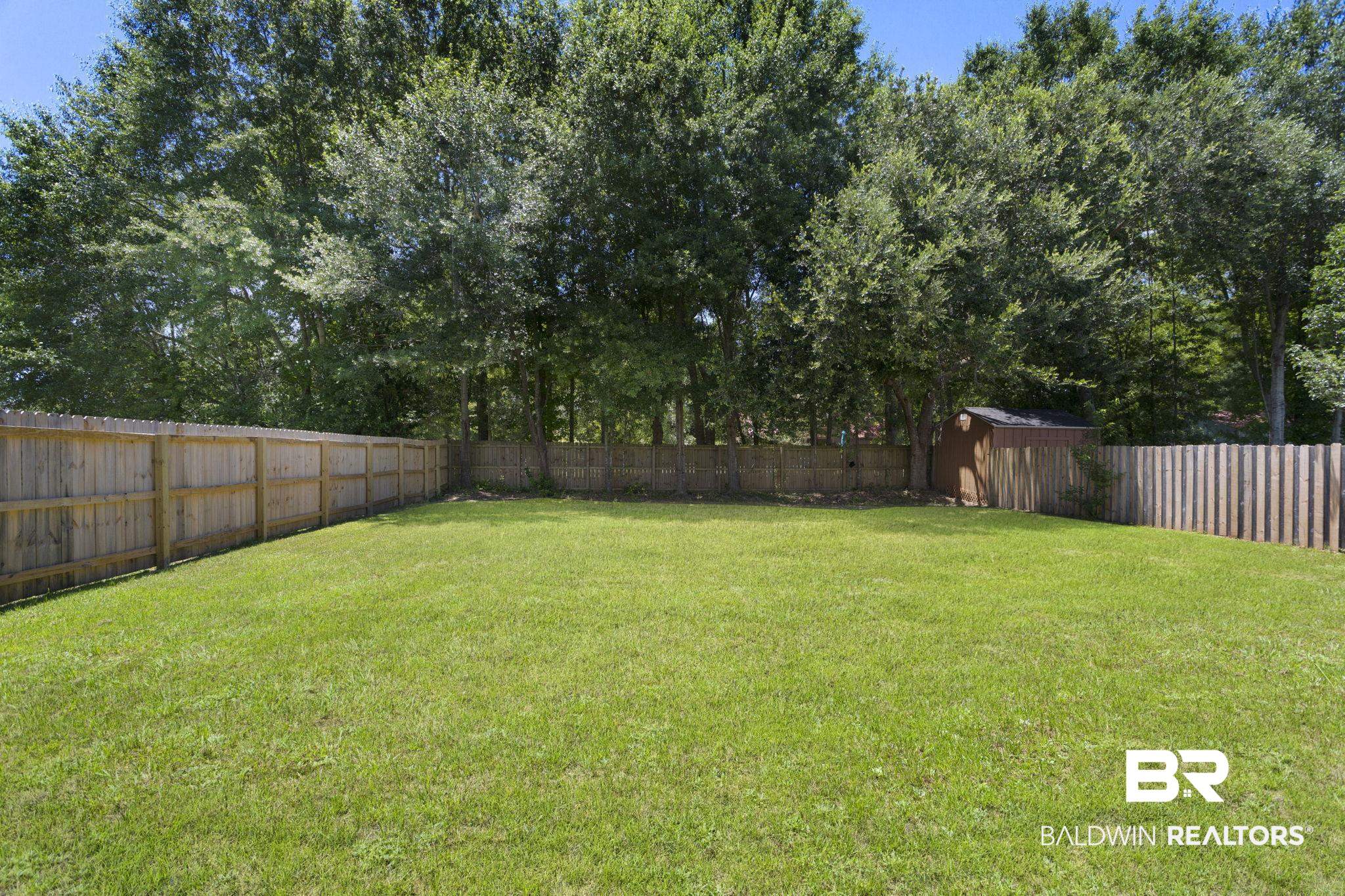 17126 Sugar Loop Foley, AL 36535 - Photo 23 of 28 Fenced backyard with a shed