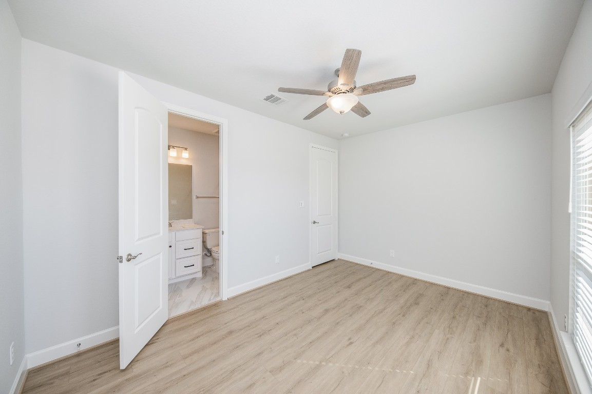 29819 Breezy Pnes Loop Fulshear, TX 77441 - Photo 11 of 50 wooden floor in an empty room with a window