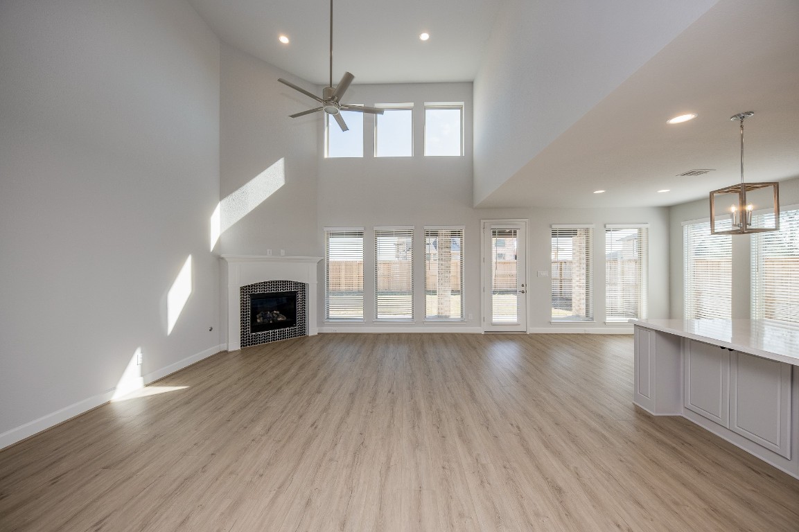 29819 Breezy Pnes Loop Fulshear, TX 77441 - Photo 18 of 50 an empty room with wooden floor and fireplace