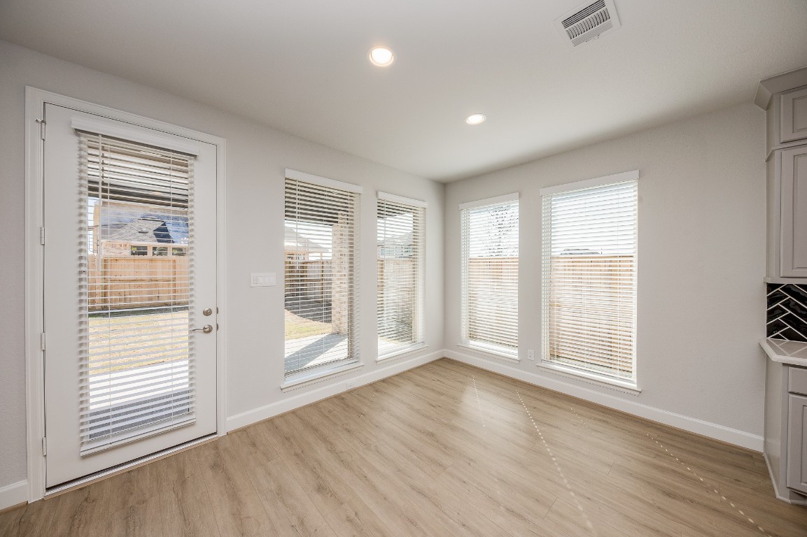 29819 Breezy Pnes Loop Fulshear, TX 77441 - Photo 22 of 50 a view of an empty room with a window and wooden floor