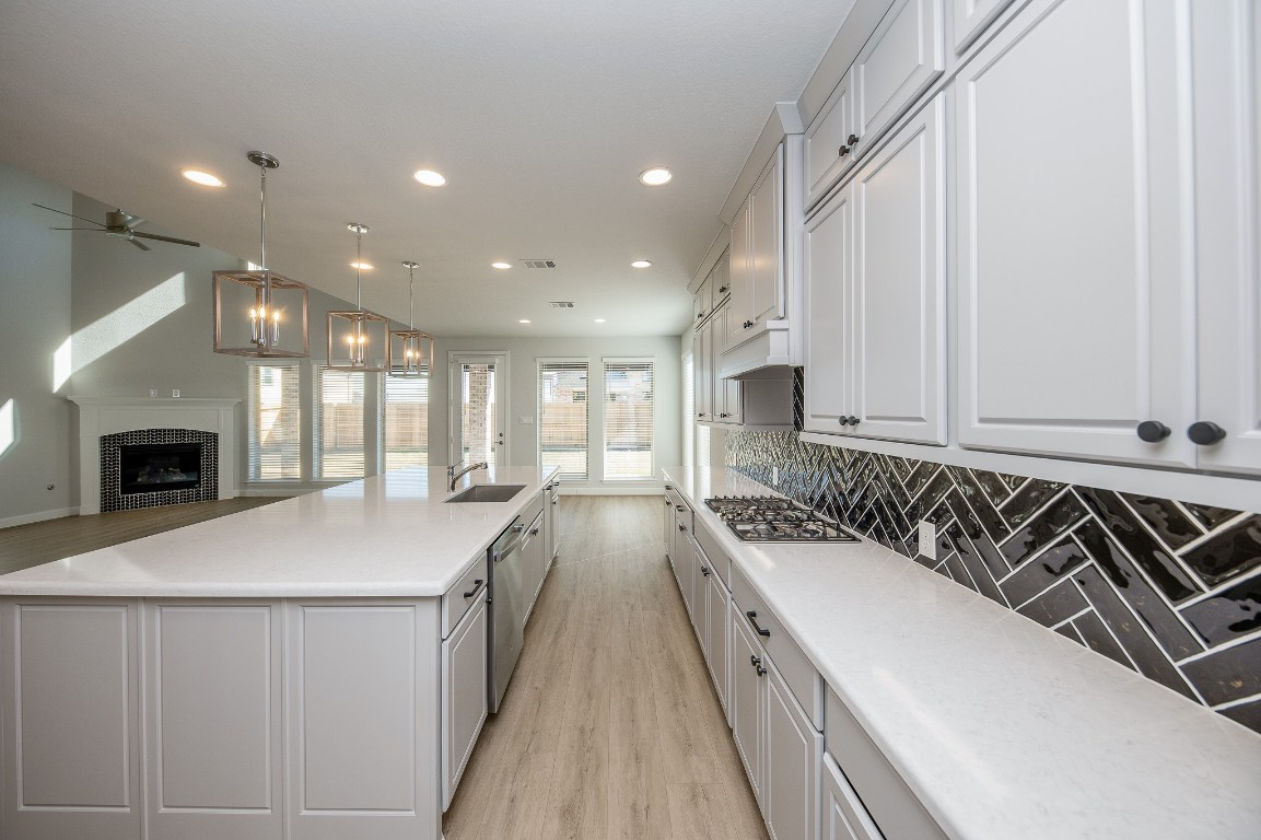 29819 Breezy Pnes Loop Fulshear, TX 77441 - Photo 27 of 50 a kitchen with a sink stove and cabinets