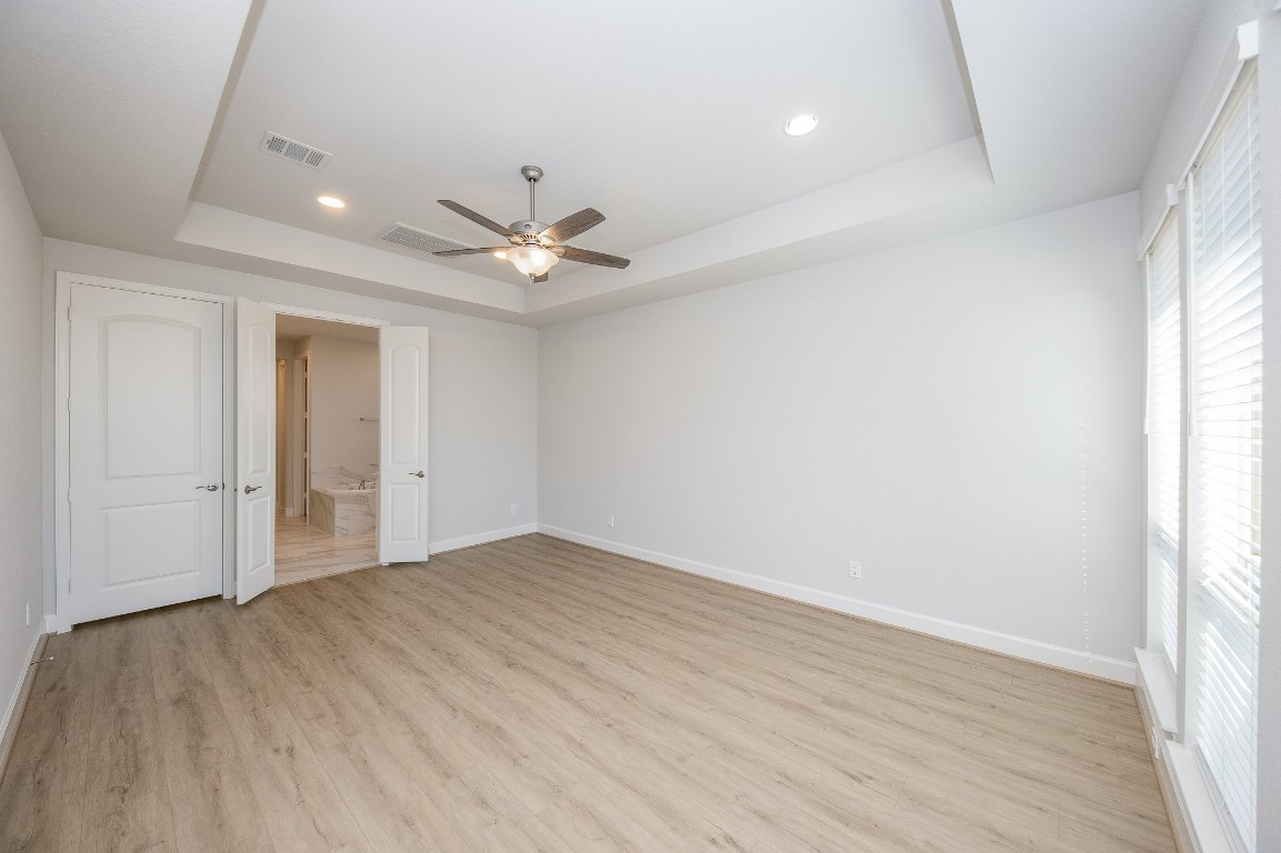 29819 Breezy Pnes Loop Fulshear, TX 77441 - Photo 35 of 50 wooden floor in an empty room with a window